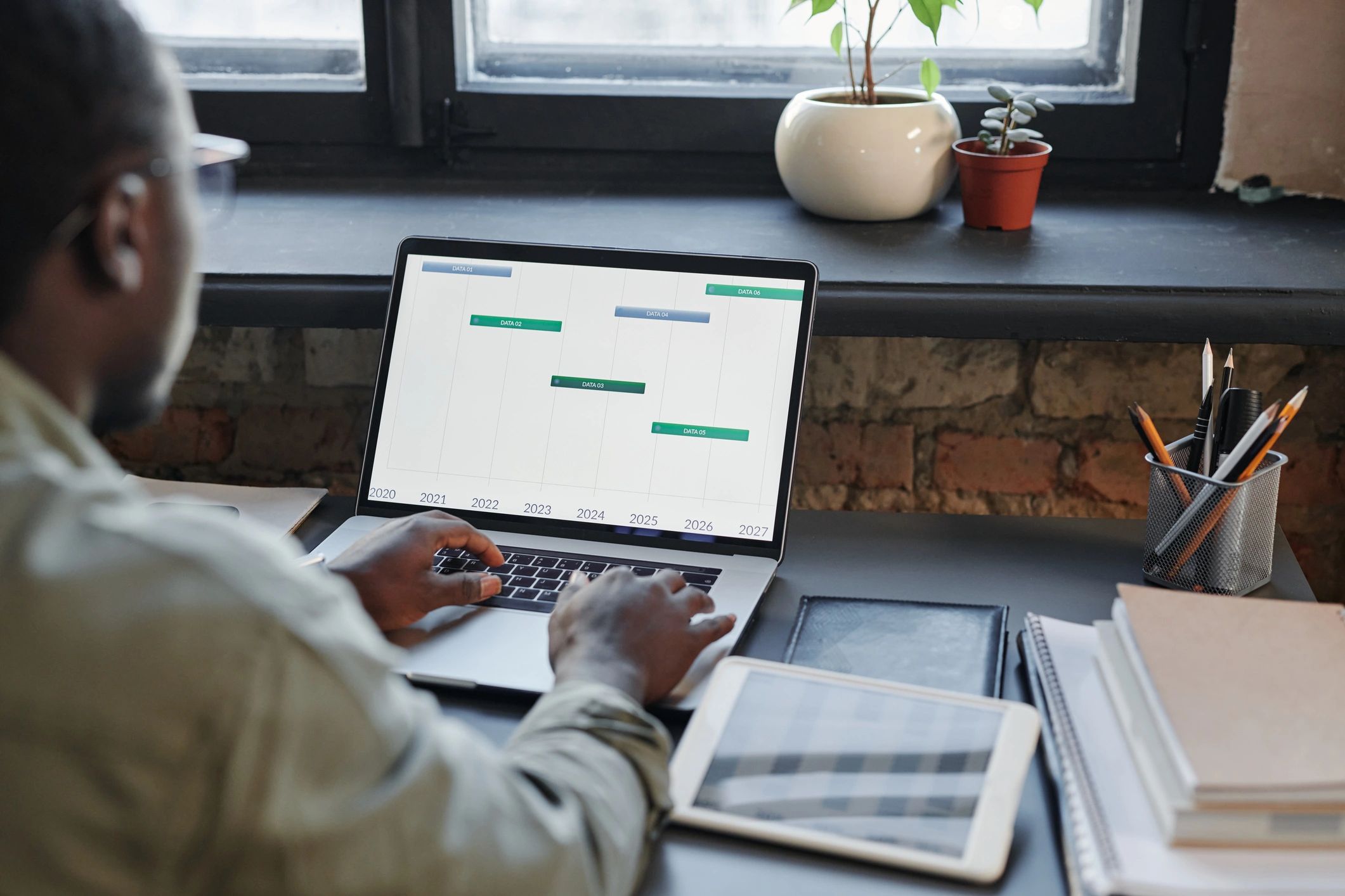 Business professional reviewing support analytics on a laptop
